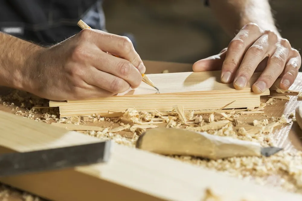 Marking a timber board with a pencil