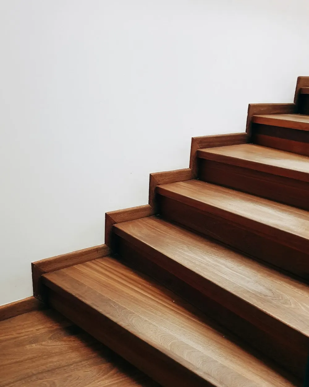 Timber staircase against a white wall
